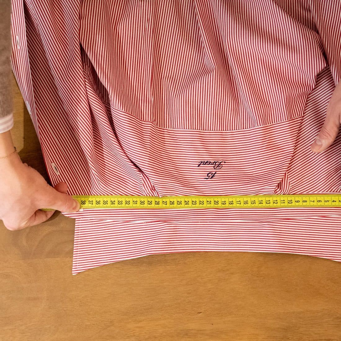 A shirt measured flat: the same medium changes from one brand to the next.