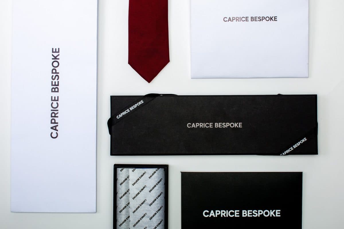 A partner brand's gift packaging: a tie, a card and an envelope.